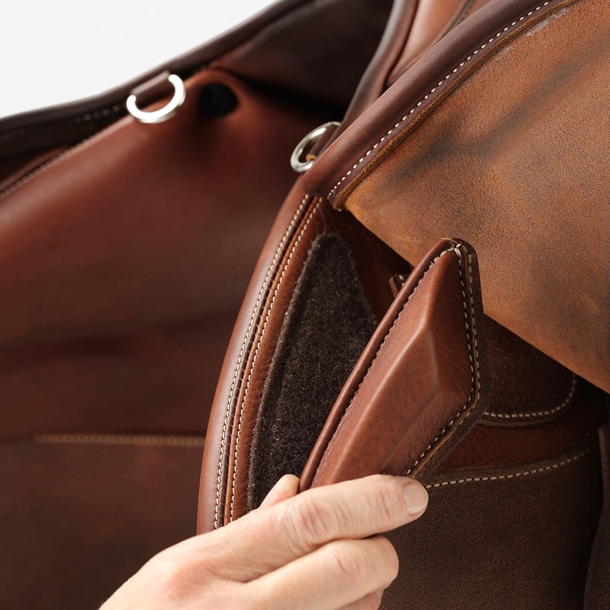 Alfa Saddlery artisan stitching leather by hand